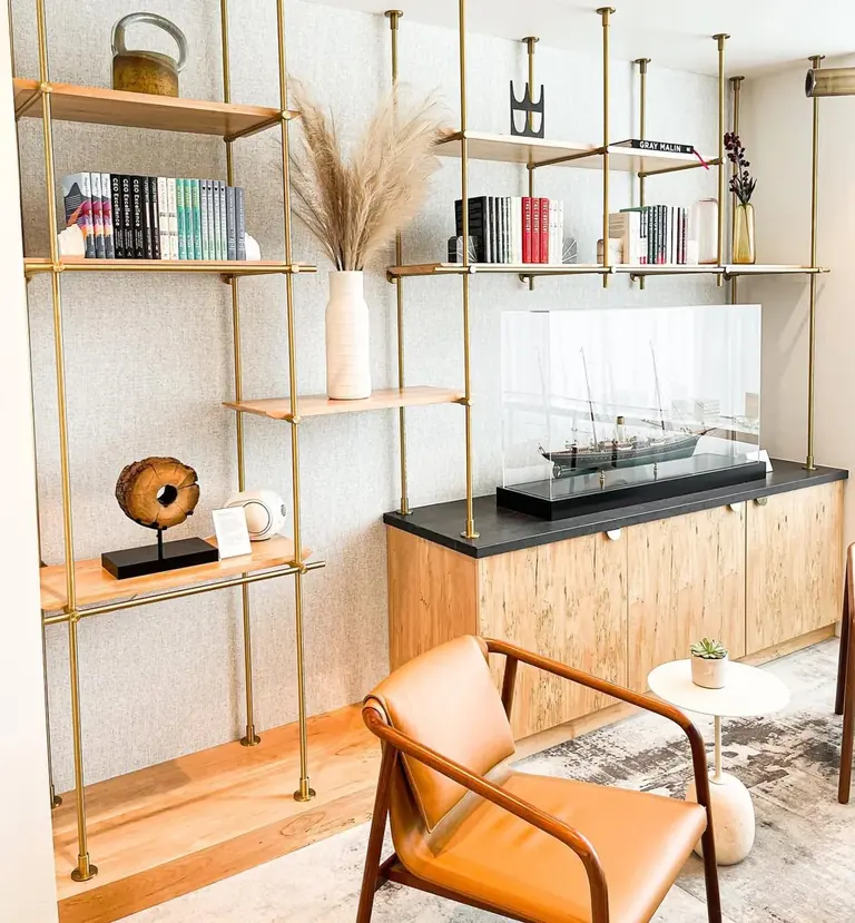 Custom wood cabinetry, walnut surrounds, and metal shelving